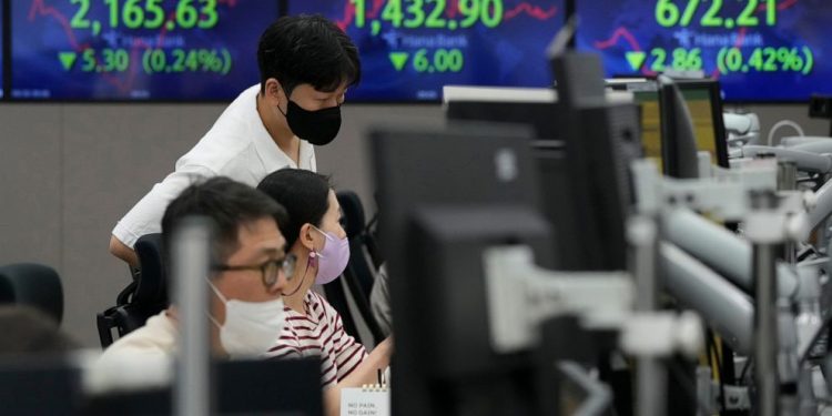 Asian stocks sink on German inflation and British tax cuts