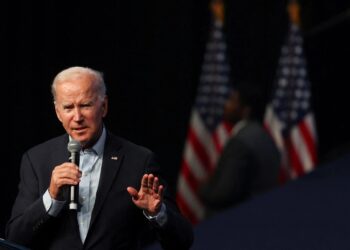 Biden warns on risk to democracy, Trump hints at another run on eve of midterms