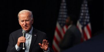 Biden warns on risk to democracy, Trump hints at another run on eve of midterms