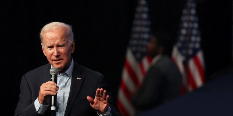 Biden warns on risk to democracy, Trump hints at another run on eve of midterms