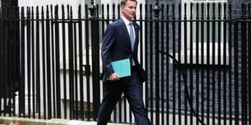 UK finance minister announces tax hikes and spending cuts, says the country is in recession