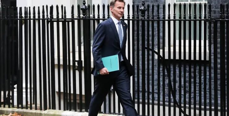 UK finance minister announces tax hikes and spending cuts, says the country is in recession