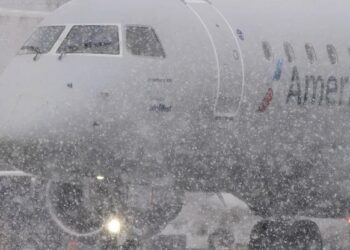 FedEx and UPS warn the storm could delay holiday packages, airlines cancel thousands of flights