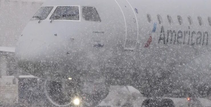 FedEx and UPS warn the storm could delay holiday packages, airlines cancel thousands of flights