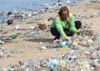 Bali is flooded with plastic waste again as tourists return to the island – as locals and a visitor in a superhero costume do their best to clean up the mess