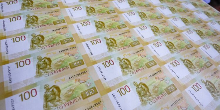 Kremlin blames loose monetary policy as rouble slides past 100 vs dollar