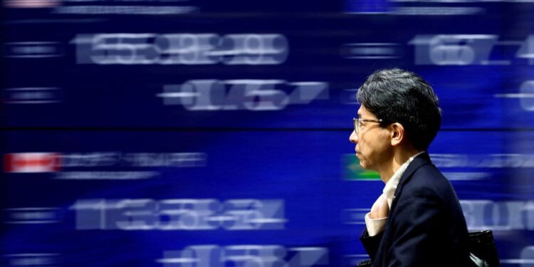 Japanese stocks rise, yen slides after BOJ’s cautious stance