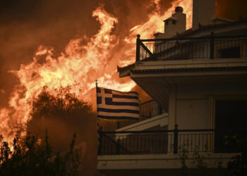 A wildfire near Greece’s capital darkens the skies over Athens and advances fast