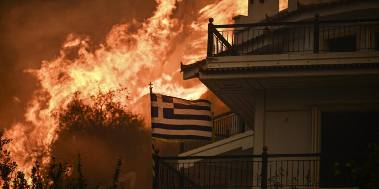A wildfire near Greece’s capital darkens the skies over Athens and advances fast
